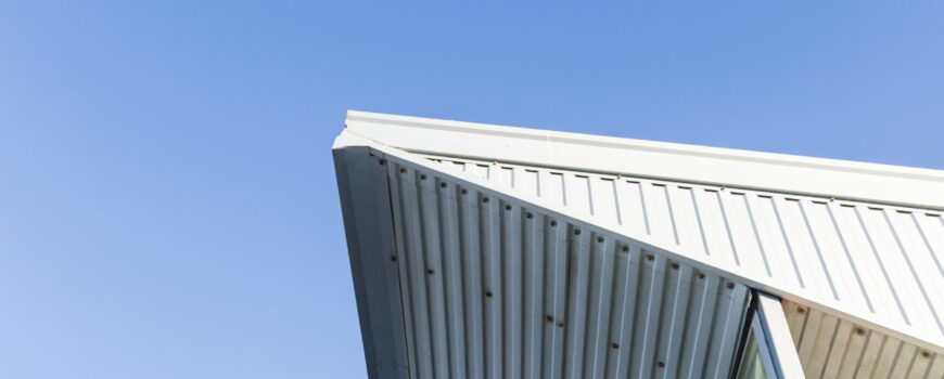 Modern flyover patio featuring white insulated roof panels with a clean, pre-finished underside for a seamless indoor-outdoor transition.